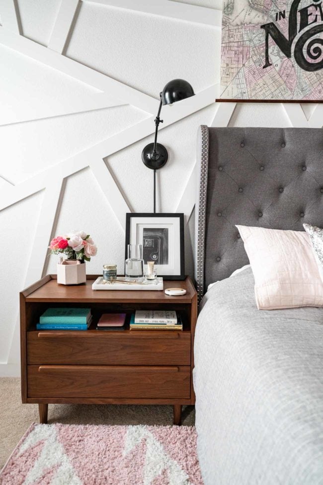Wood MCM Nightstand with wall mounted lamp on white modern accent wall.