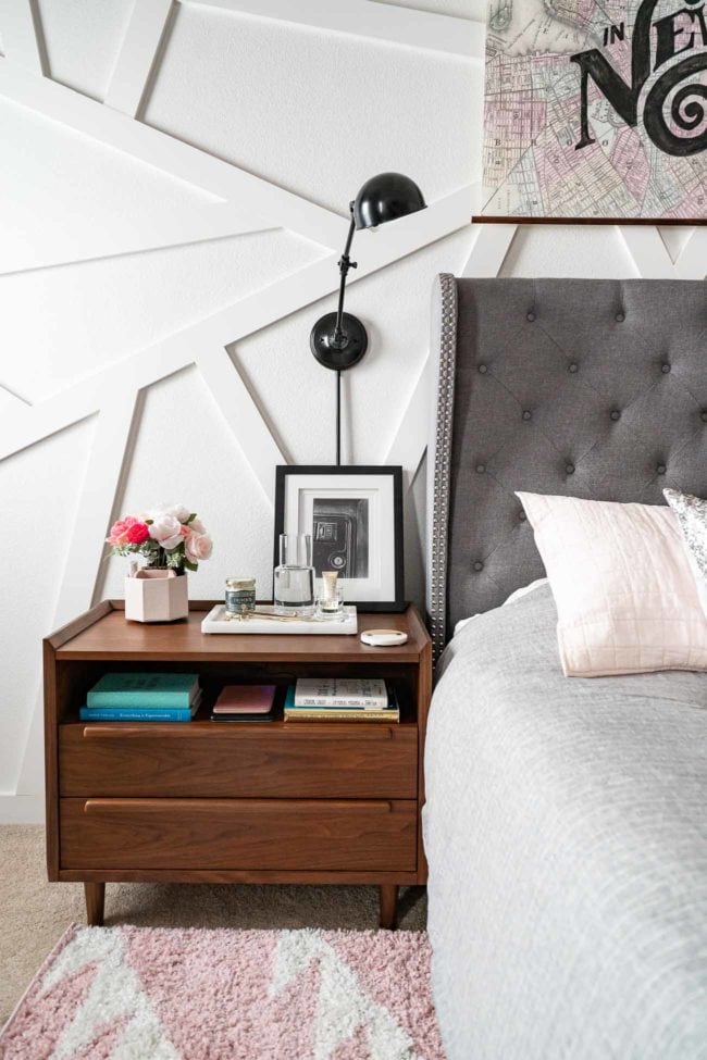 Wood MCM Nightstand with wall mounted lamp on white modern accent wall. 