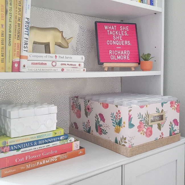 White bookcase with letter board and pink box with letter board letter containers