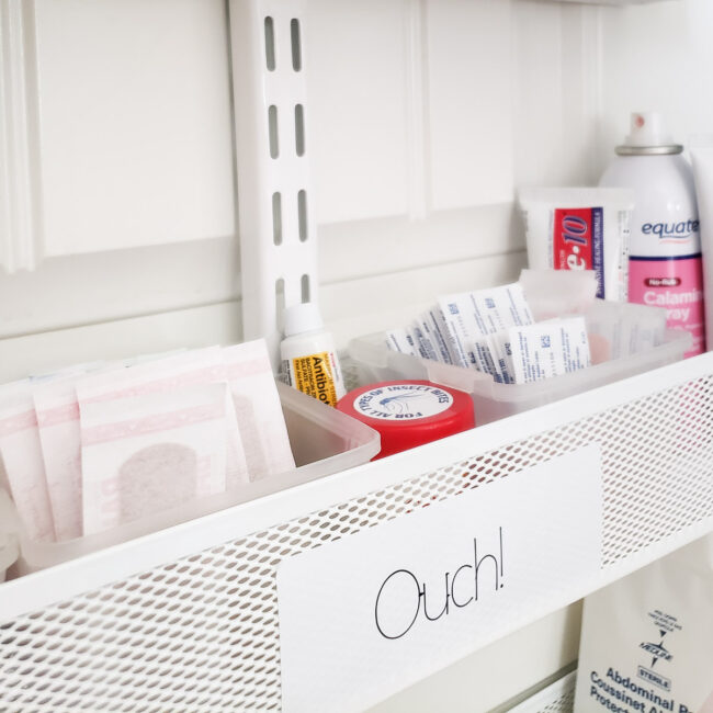 closet up of white first aid bin labeled Ouch