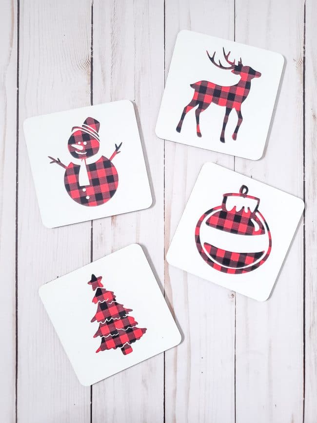 Four white coaster with various holiday buffalo check designs