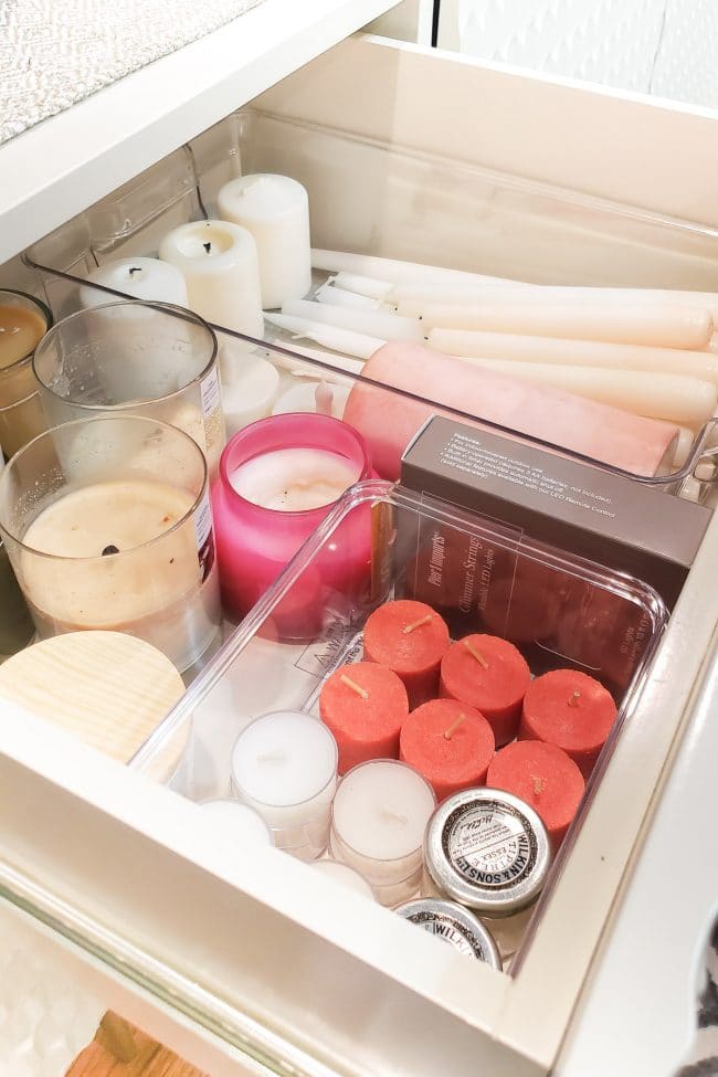 Drawer with various candles seperated into clear bins