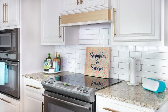 White kitchen with granite countertops and wood sprinkles & S'mores tray