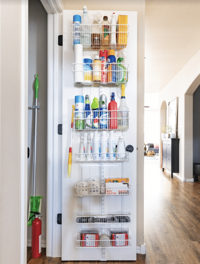 Open Hallway Door with Organized Rack of Cleaning Supplies mounted to the door