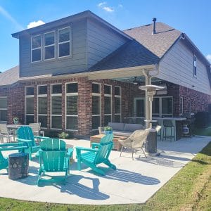 backyard patio with turquoise adirondak chairs