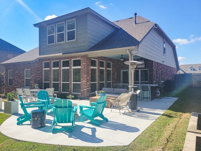 backyard patio with turquoise adirondak chairs