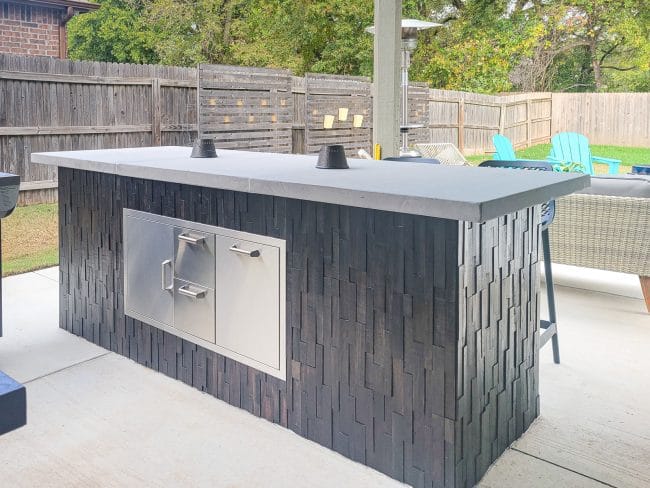 outdoor dark wood bar with light gray counter