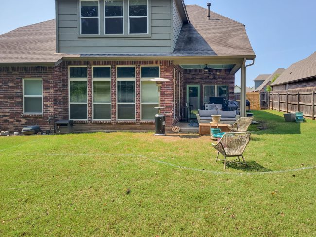 grass and back of two story home